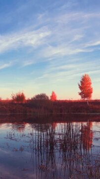 Sunrise timelapse over calm autumn lake