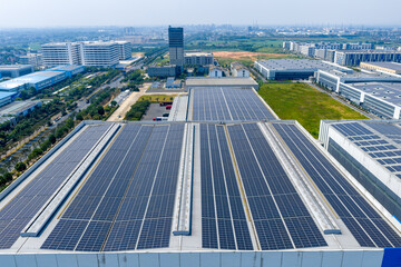Neatly arranged solar photovoltaic panels on the industrial building roof © zhangyang135769