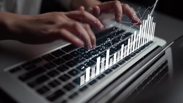 Close-up view of hands typing on a laptop keyboard with data visualization elements, emphasizing technology and analysis in a modern business environment. Copula