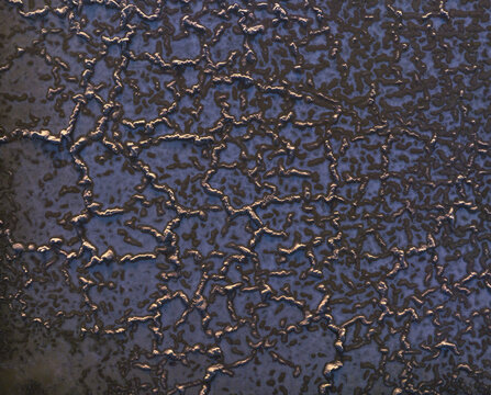 Aerial view of salt flats with intricate cracked patterns and crystalline textures in Las Palmas, Canarias, Spain.