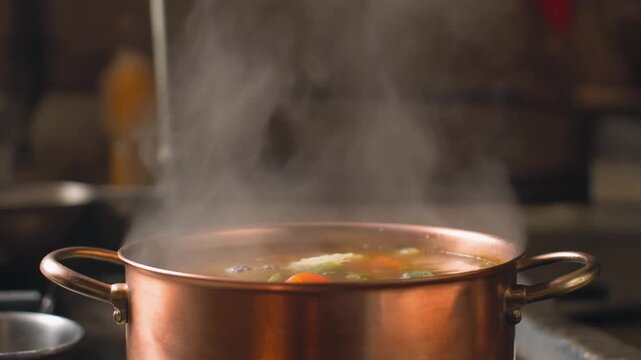 Steam rising from a copper soup pot