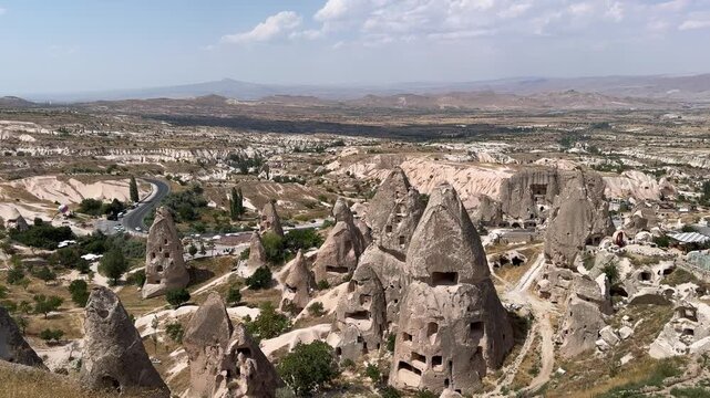 Cave dwellings in tuff rocks near Uchisar Castle in Cappadocia, Turkey.
