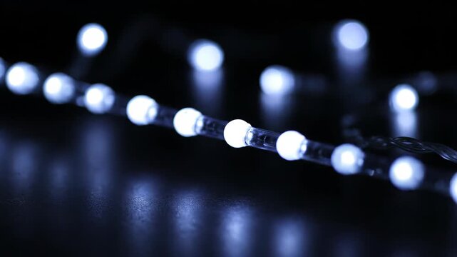 Close-up of white string lights, white LED string lights flashing