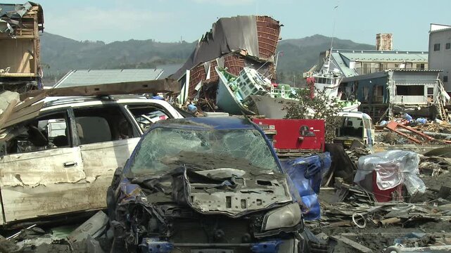 Destroyed Vehicles And Debris In Aftermath Of Tsunami In Japan