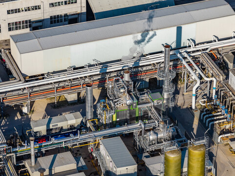 Aerial view of an industrial facility featuring complex piping systems, storage tanks, and metal structures in Nera Montoro, Umbria, Italy.