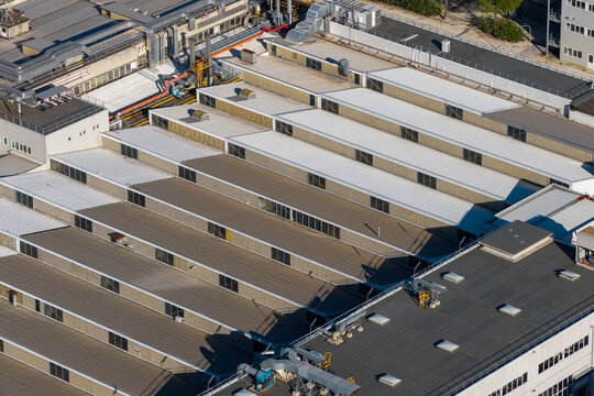 Aerial view of an industrial factory building with a characteristic sawtooth roof and skylights in Nera Montoro, Umbria, Italy.