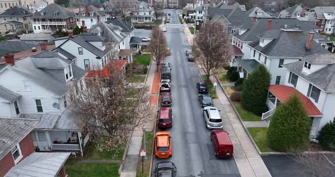 Aerial view of Derry Township residential street lined with houses, parked cars, and trees in Hershey, Pennsylvania, United States.