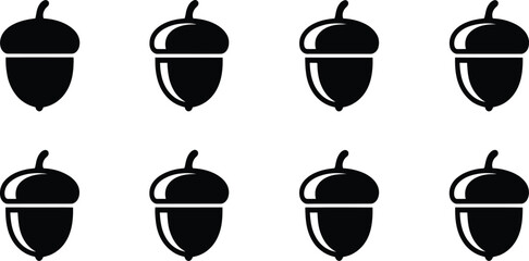 Black acorn icon set featuring simple nut silhouettes with varied highlights for autumn nature branding and decorative designs © MdJamilUddin