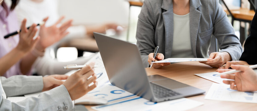 Close Up Businesspeople Hands Working on Laptop and Financial Documents