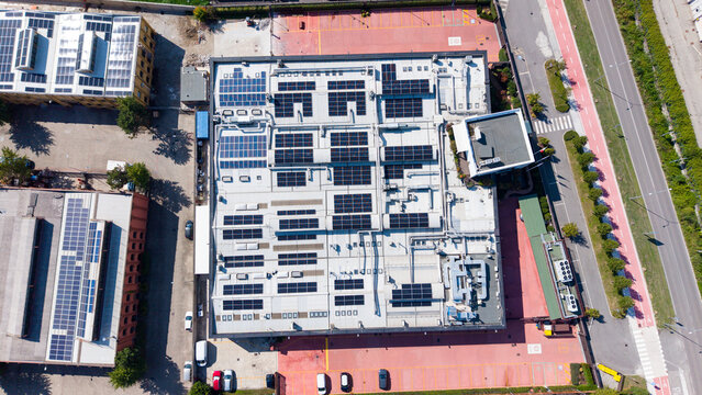 Aerial view of a food additive manufacturing plant with rooftop solar panels and industrial equipment in Milan, Lombardy, Italy.
