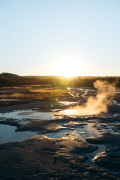 Sunstar Over a Steaming Geyser Basin at Sunrise