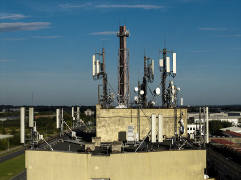 Aerial view of telecommunications antennas and a chimney stack mounted on a rooftop in Krakow, Lesser Poland Voivode, Poland.