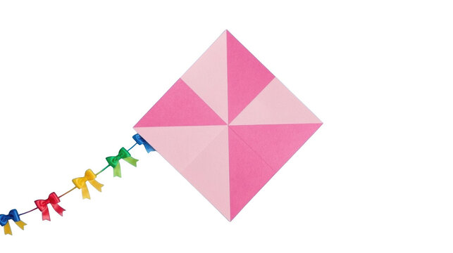 Pink origami kite with colorful paper streamers attached to a string floats against a transparent background.