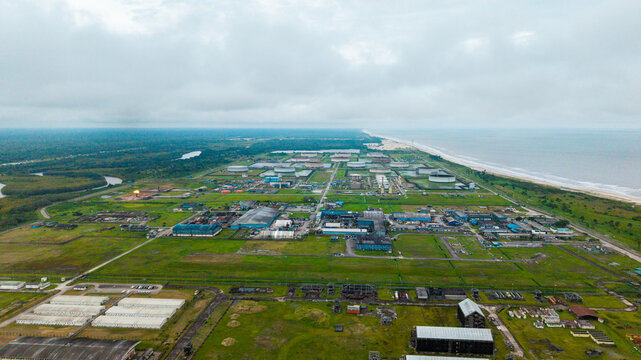 Aerial view of the industrial oil and gas facility near Ibeno Beach, featuring storage tanks, processing units, and pipelines set against the coastline in Kwa Ibo, Akwa Ibom, Nigeria.