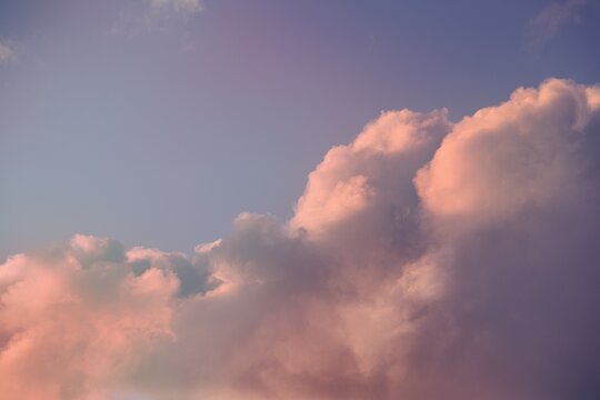 Soft Pink Clouds at Sunset Against a Pastel Blue Sky
