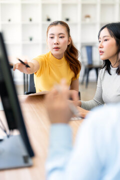 Asian Businesswoman Pointing Pen at Screen and Discussing Data in Vertical Framing