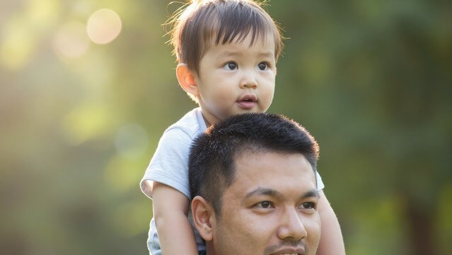 Father and Child Enjoying Time Together Outdoors in Warm Light