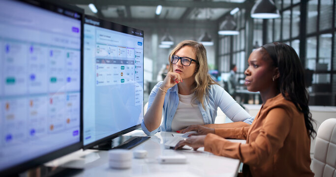 HR Manager Reviews Employee Performance Data With Colleague