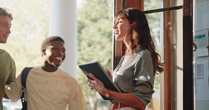 Teacher, students and walk in college with greeting, class register and welcome at lecture hall door. Happy, professor and people at university with arrival, morning and book for attendance record.