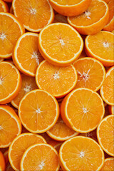 Vibrant background of fresh sliced oranges top view concept for healthy organic juice and fruit diet © Ricko