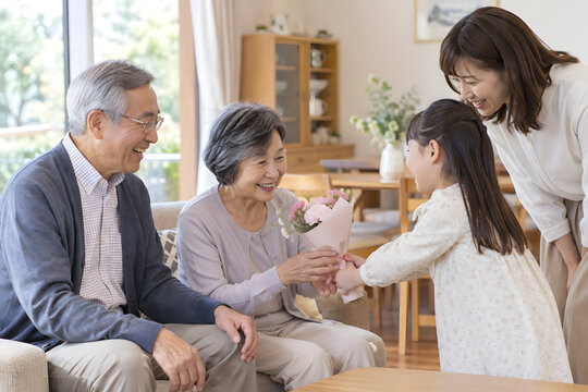 Grandparents spending time with their young granddaughter at home