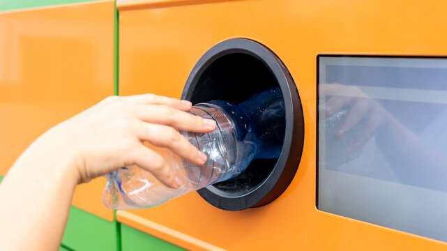 Plastic bottle inserted into reverse vending machine.