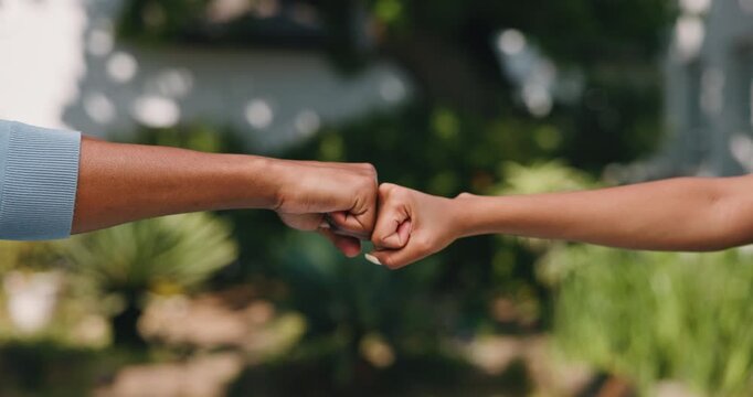 Friends, hands and fist bump outdoor with bonding together, support and appreciation for community. People, secret handshake and friendship in garden with respect, connection and special greeting.