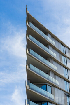 Looking up a modern apartment block with a modertn angular facade