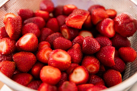 cut and washed strawberries in a colander