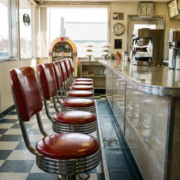 Vintage diner interior with red stools and retro decor  