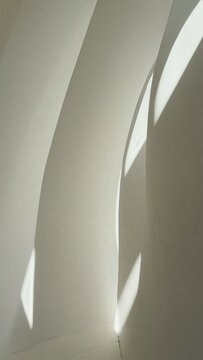 Curved white wall with soft light patterns