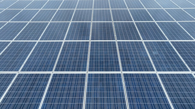 Aerial view of a large array of blue photovoltaic solar panels arranged in a geometric grid pattern in Neffsville, Pennsylvania, United States.
