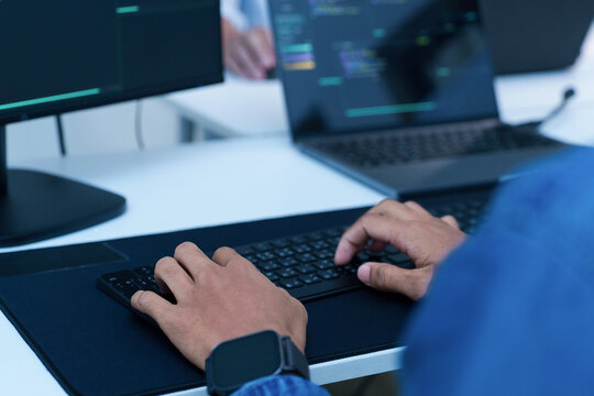 Programmer Writing Code on a Laptop