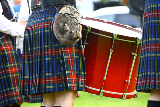 Close up of a Scottish pipe band drummer in a traditional kilt