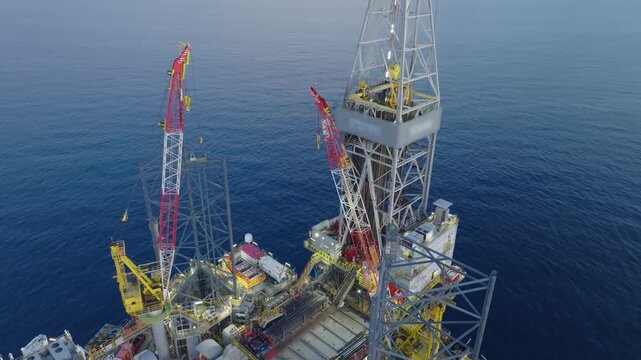 Offshore drilling rig - jack up and offshore platform during sunset for oil and gas exploration and production. 