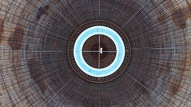 Aerial view of wind turbine foundation construction featuring intricate circular steel rebar reinforcement mesh and central structure in Latvija.