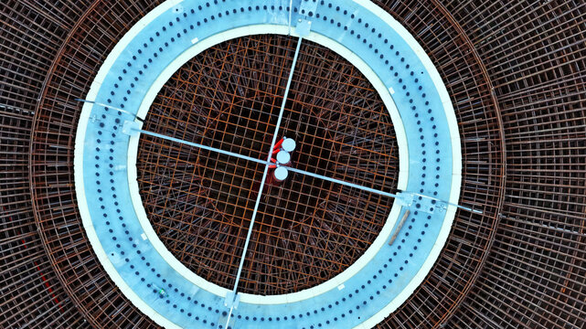 Aerial view of wind turbine foundation with circular rebar reinforcement and concrete base in Latvija.