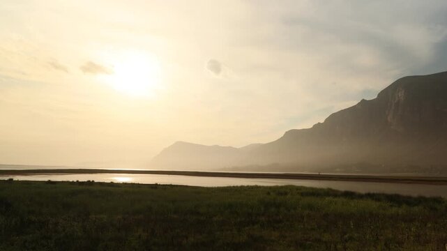 placid lagoon reflecting Klein Mountains, Stanford, South Africa at sunset