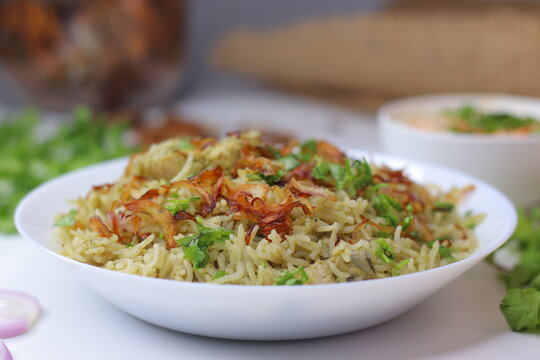Green chicken pulao with fragrant rice, tender chicken, fried onions and fresh coriander garnish