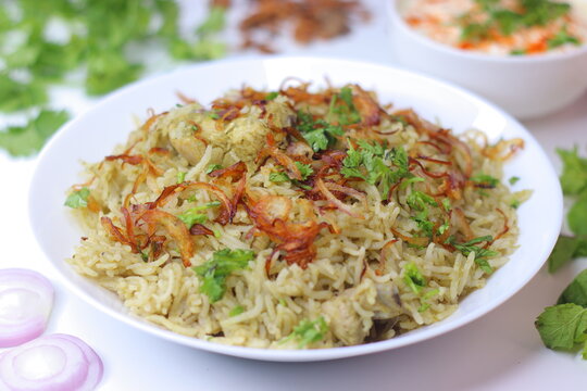 Green chicken pulao with fragrant rice, tender chicken, fried onions and fresh coriander garnish
