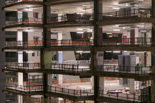 A refurbishment of a multi-level building showing the exposed floors during the night
