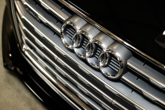 Krakow, Polska - September 06, 2026: Audi grille close up with four interlocking rings, chrome horizontal bars, glossy black finish, and detailed front emblem on a luxury vehicle