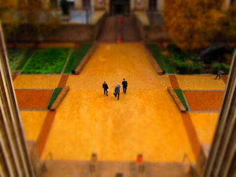 High angle tilt shift view of businessmen walking