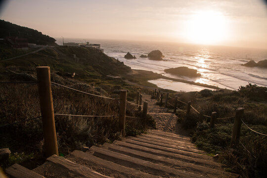 Wooden stairs leading to Sutro Baths at sunset