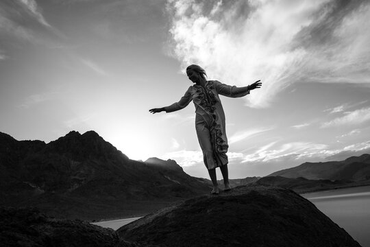 Woman in a caftan finds balance in nature