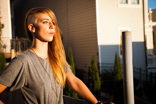 Edgy young woman with undercut at golden hour
