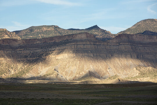 Sunlight and shadows move across desert mountains
