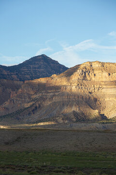 Golden light hits sandstone cliffs in the desert