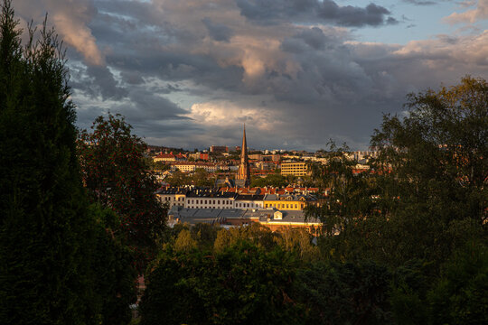 Oslo cityscape view with a church spire at sunset