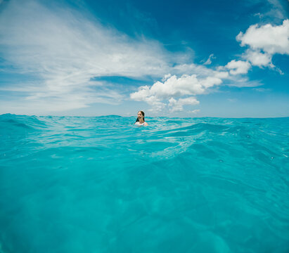 Woman enjoying a swim in beautiful tropical water